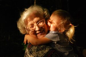 woman in black and white striped shirt hugging girl in black and white striped shirt